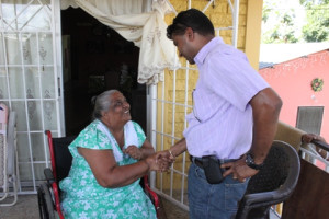Wheel chair bound Phyllister Sookhan, 65, would like the assistance of Minister Ramadharsingh, right, in acquiring the services of a home care assistance.