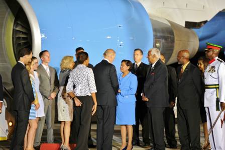 Prime Minister Kamla Persad Bissessar greets the US Vice President Joe Biden at Piarco International Airport