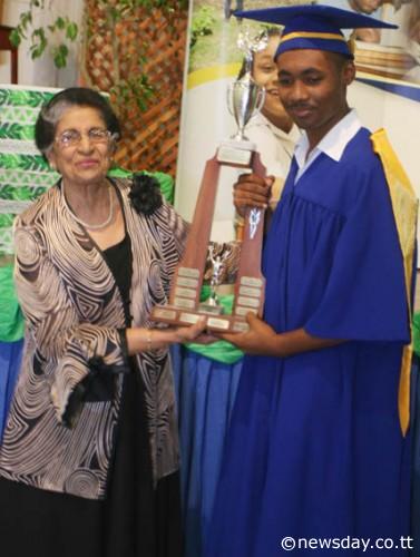AWARD PRESENTATION: Lady Zalayhar Hassanali, widow of late president Noor Hassanali, presents the award to Most Outstanding Trainee of 2013, Joshua Sahadeo, right, who was also the valedictorian of 2013.