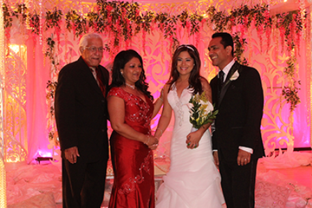 Former Prime Minister and former leader of the United National Congress (UNC) Basdeo Panday, left, and his wife Oma, congratulate UNC activist Ken Emrith, right, and his bride Davica Persad who exchanged marriage vows during a lavish ceremony and reception attended by several government ministers at the Centre of Excellence, Macoya, yesterday. PHOTO: DARREN RAMPERSAD
