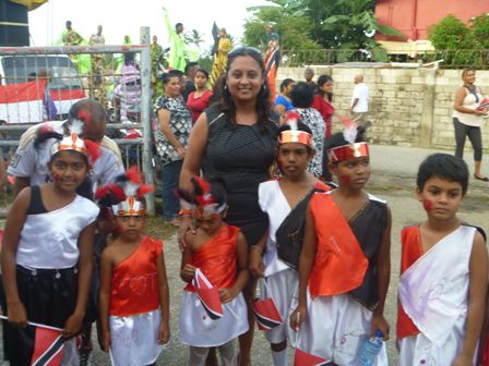 Couva North Member of Parliament, the Honourable Ramona Ramdial (centre) poses with Orange Valley youths who paraded at Independence Day Celebrations on Saturday