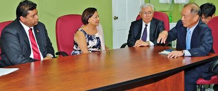 Prime Minister Kamla Persad-Bissessar, second left, listens to as Executive Vice President of the Mitsubishi Corporation Takahisa Miyauchi, right, as Chairman of Mitsubishi Gas Chemical Kazuo Sakai and Minister of Energy and Energy Affairs look on.