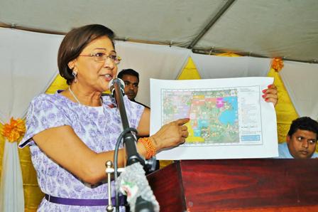  PM Persad-Bissessar holds up the map showing the areas where the residents are seeking land. 
