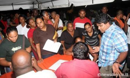 HARD AT WORK: Housing Minister and Oropouche East MP Dr Roodal Moonilal, right, speaks to residents of Picton near Golconda during his Monday Night meet-the-constituents.  Author: ANIL RAMPERSAD