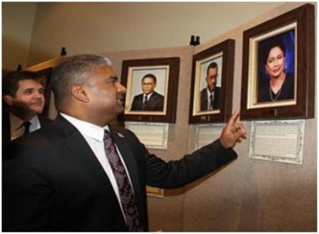 Attorney General Anand Ramlogan looks at a photograph of Prime Minister Kamla Persad-Bissessar during the commissioning ceremony of the law museum of T&T at the old Cabildo Building, Sackville Street, Port-of-Spain, yesterday. The photograph was taken when she was the attorney general in the Basdeo Panday-led UNC government. Photos: Trinidad Guardian