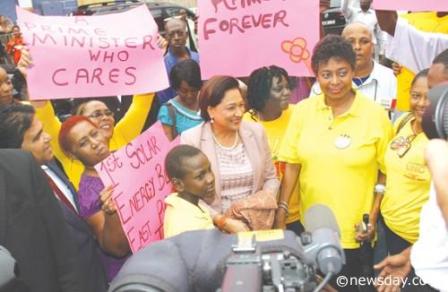 BACKING KAMLA: Surrounded by placard bearing supporters, Prime Minister Kamla Persad- Bissessar met with residents of Duncan Street Port-of-Spain after she formally opened the Duncan Street Police Post. Author: SUREASH CHOLAI