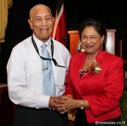 MEDIA GREETINGS: Prime Minister Kamla Persad-Bissessar, right, greets veteran journalist John Babb, Snr Associate Editor at yesterday's annual Media Christmas luncheon at the Diplomatic Centre, St Ann's. Babb,a journalist for 67 years moved a vote of thanks on behalf of media practitioners present  Author: Azlan Mohammed 