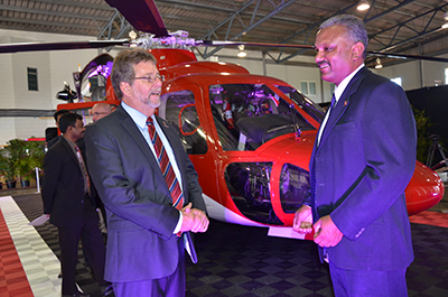 Transport Minister Stephen Cadiz and Couva South MP Rudranath Indarsingh in front of the Sikorsky D76 at yesterday’s launch of the new aircraft. Photo: Shastri Boodan. guardian.co.tt