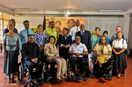  Prime Minister Kamla Persad-Bissessar poses for a photo with members of the Consortium of Disability Organisations in St Ann's today. PHOTO COURTESY THE OFFICE OF THE PRIME MINISTER.