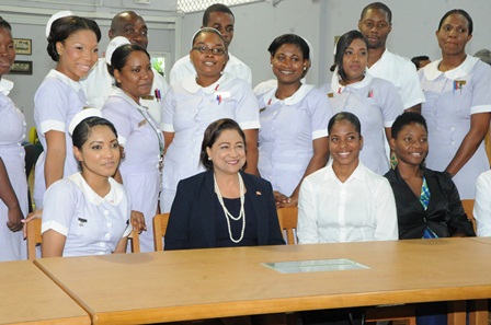Prime Minister Kamla Persad-Bissessar SC poses with student nurses at the Academy of Nursing and Allied Health in El Dorado this afternoon.