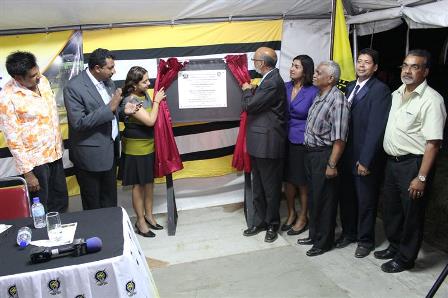 Couva North Member of Parliament, Ramona Ramdial (3rd from left) and Public Utilities Minister, Nizam Baksh (4th from left) unveil the commemorative plaque along with T&TEC officials and stakeholders