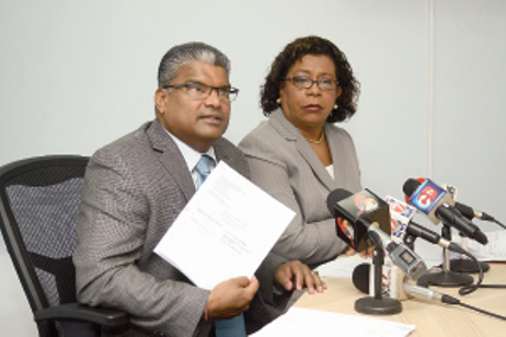 DOCUMENTS IN HAND: Attorney General Anand Ramlogan shows a certified affidavit from Google Inc, which he claims refutes the validity of the “Emailgate” scandal, while Senior Counsel Pamela Elder looks on during a press conference at Ramlogan’s office on St Vincent Street, Port of Spain, yesterday. –Photo: ISHMAEL SALANDY