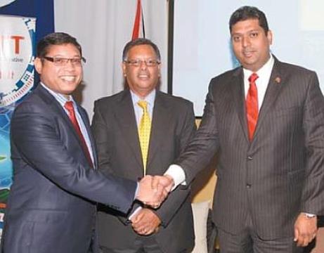 Energy and Energy Affairs Minister Kevin Ramnarine, right, shakes hands with executive director of the Unit Trust Corporation of T&T, Ian Chinapoo. At centre is as executive director of the Planning Ministry’s Economic Development Board, Dr Rikhi Permanand. The three men were at yesterday’s national release of the Global Competitiveness Report 2014 at the Yara Auditorium, Arthur Lok Jack Graduation School of Business, Mt Hope. PHOTO: SHIRLEY BAHADUR