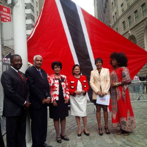 Prime Minister Kamla Persad-Bissessar SC, centre, poses in front of the national flag. Others from left are Nick Perry, Deputy Majority Leader, 58th Assembly District, Minister of Foreign Affairs, Winston Dookeran, Consul General, Nam Ramgoolam, Felicia Persaud, and Collette Burnett. 