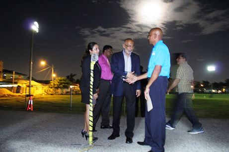 Public Utilities Minister, Nizam Baksh (3rd from left) congratulates Orange Valley Village Council President, Mukesh Babooram as lights on the Orange Valley Recreation Ground are turned on for the fist time