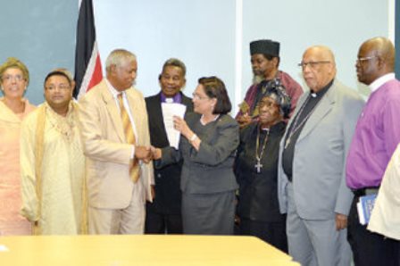 rescue mission: Prime Minister Kamla Persad-Bissessar greets head of the Inter Religious Organisation (IRO) Brother Haripersad Maharaj during a meeting with the organisation at the Prime Minister’s Office in Port of Spain yesterday. Looking on are Spiritual Baptist head Barbara Burke, Roman Catholic Archbishop Fr Joseph Harris and at far right, head of the Maha Sabha, Sat Maharaj. —Photo: CURTIS CHASE