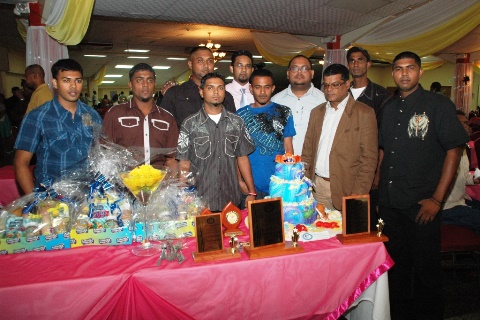 FCFA Executive Members David Bachan and Avalon Seeram stand with Omardath Maharaj and the winners.
