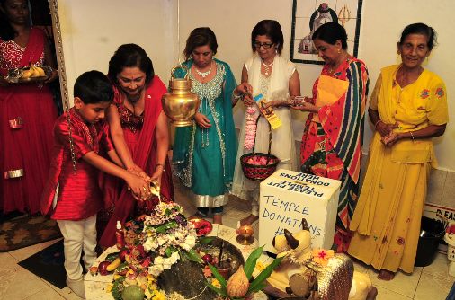 Prime Minister Kamla Persad-Bissessar SC, assisted by her grandson Kristiano,  performs puja in celebration of the Hindu Festival of Maha Shiva Raatri at the Patiram Trace Temple, Penal, on Tuesday night.