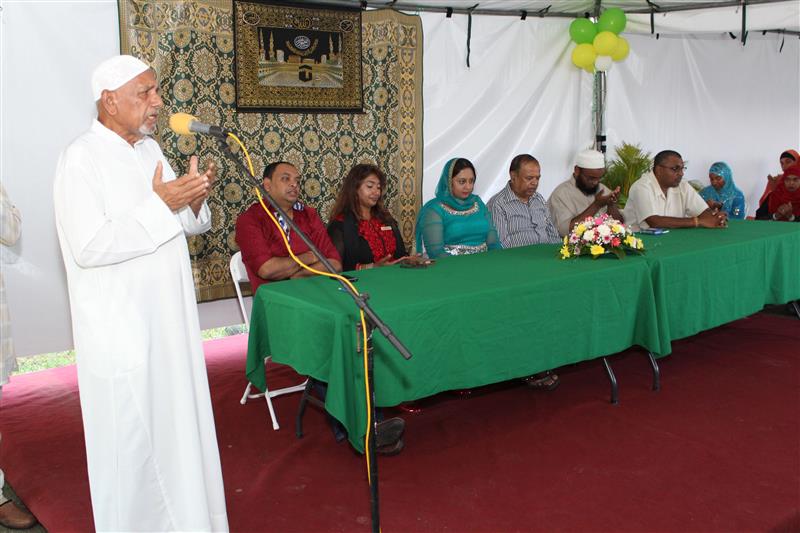 Imam Masahood Aziz (left) of the Orange Valley Muslim Jamaat conducts the closing prayer