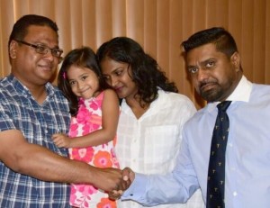 SURGERY IN MAY: Attorney Gerald Ramdeen, right, meets with the Luke family at his law chambers in Woodbrook last week. From left are parents Arthur Luke and Michelle Kallie-Luke holding their four-year-old daughter, Shannen. Image Courtesy: Trinidad Express 
