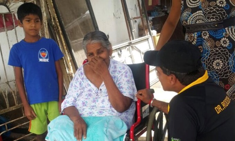 Dr Roodal Moonilal consoles 75 year old Jasso Sookdeo of Suchit trace who was forced to evacuate her home in the aftermath of the storm 