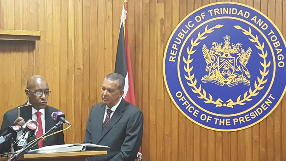 Robert Le Hunte (left) being sworn in as Public Utilities Minister alongside President Anthony Carmona (right).