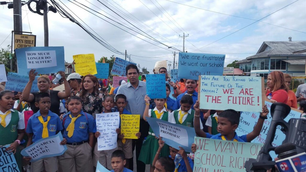  In pic Dr Roodal Moonilal and councillor Kumarie Kuarsingh join the children and staff of the Ramai trace Hindu school in protest. 